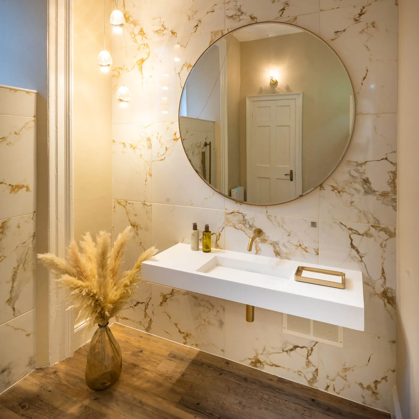 Marble washroom with brass fittings and dried pampas at The Row, Edinburgh