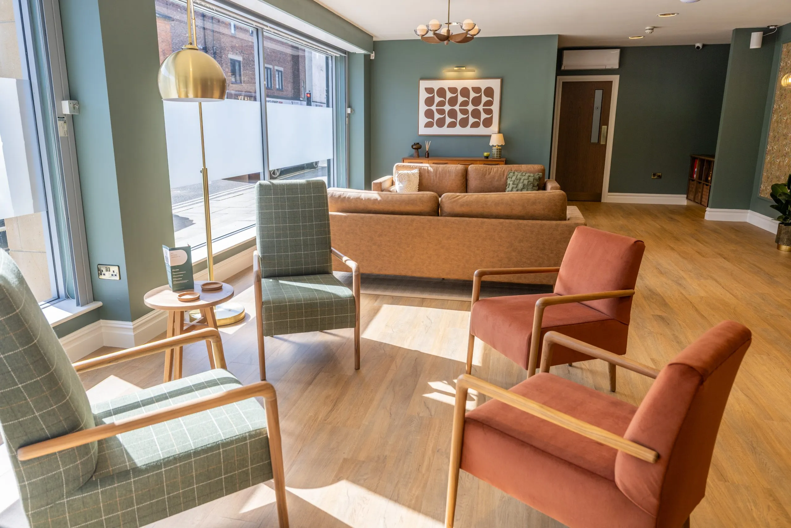 Mid-century style seating in the bright waiting area at Roots Dental, Morpeth