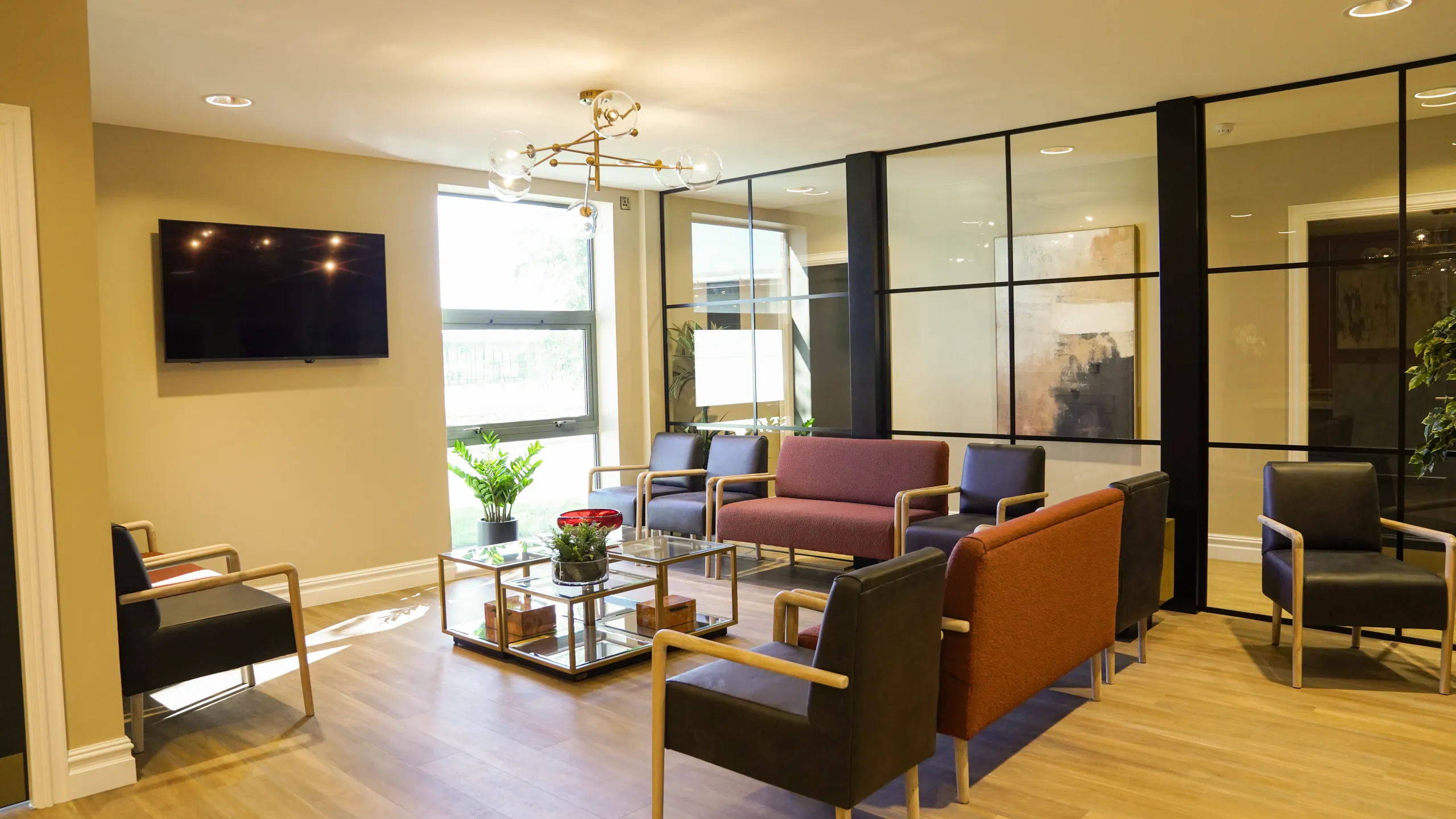 Patient waiting lounge with plum and tan seating at Westmount Dental