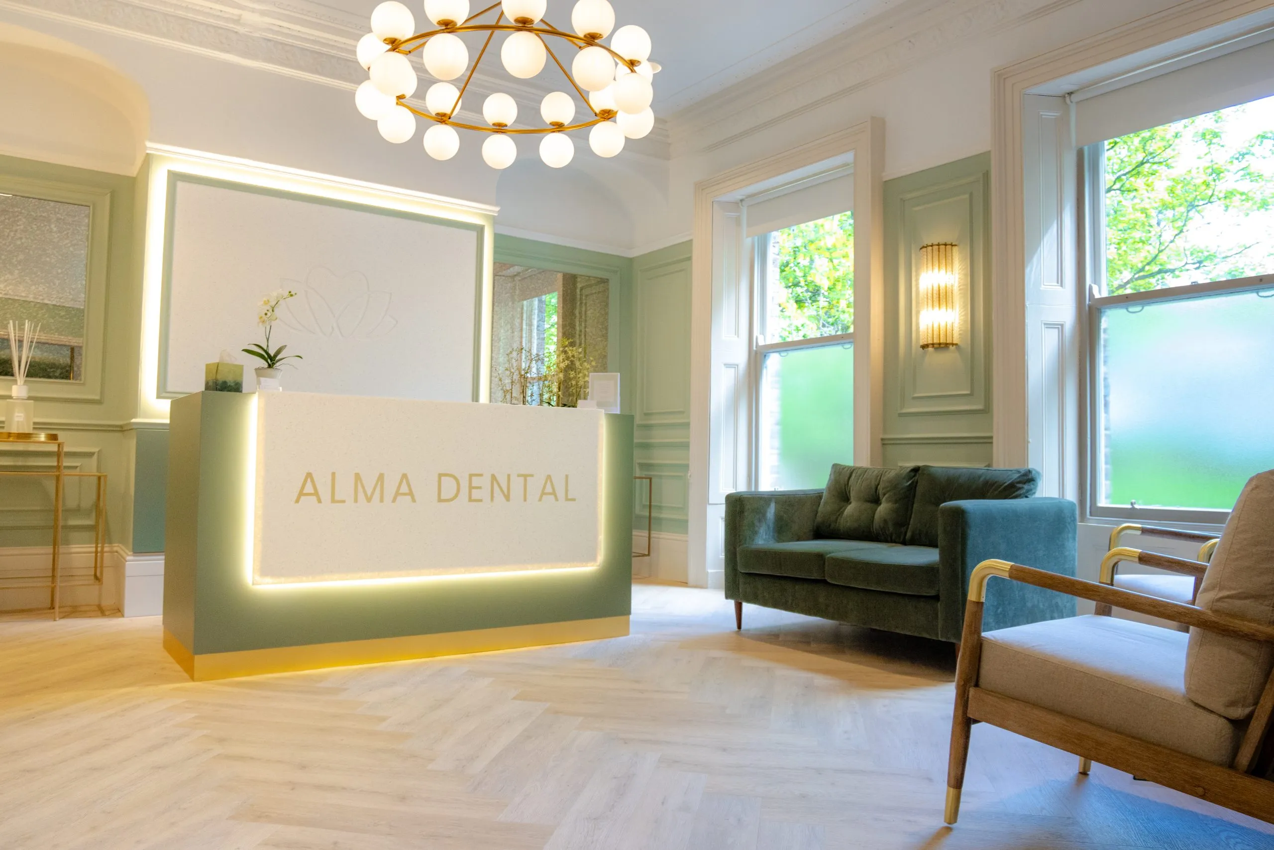 Panelled waiting area with sage walls and bay window at Alma Dental, North Shields