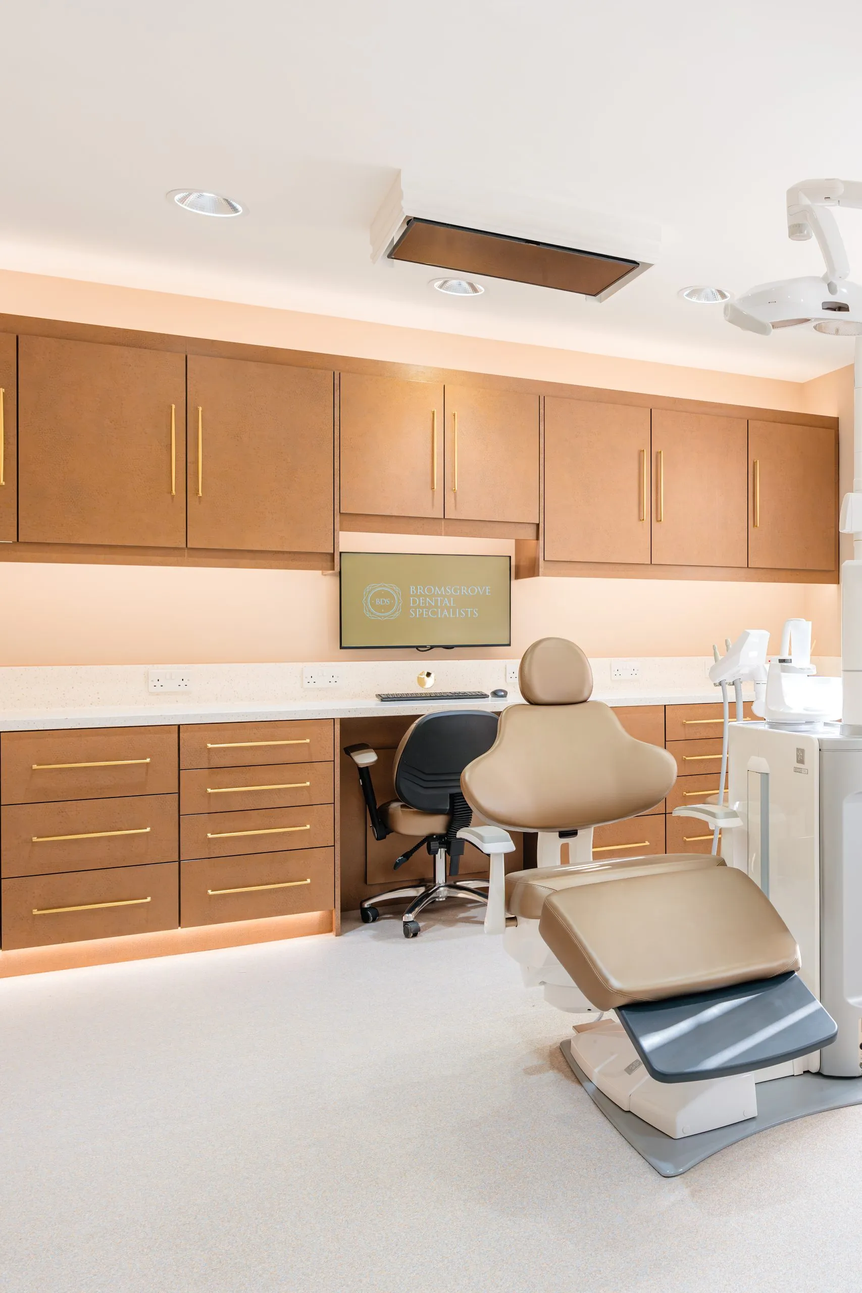 Dental surgery with bespoke tan cabinetry at Bromsgrove Dental Specialists, designed by BH Projects Group