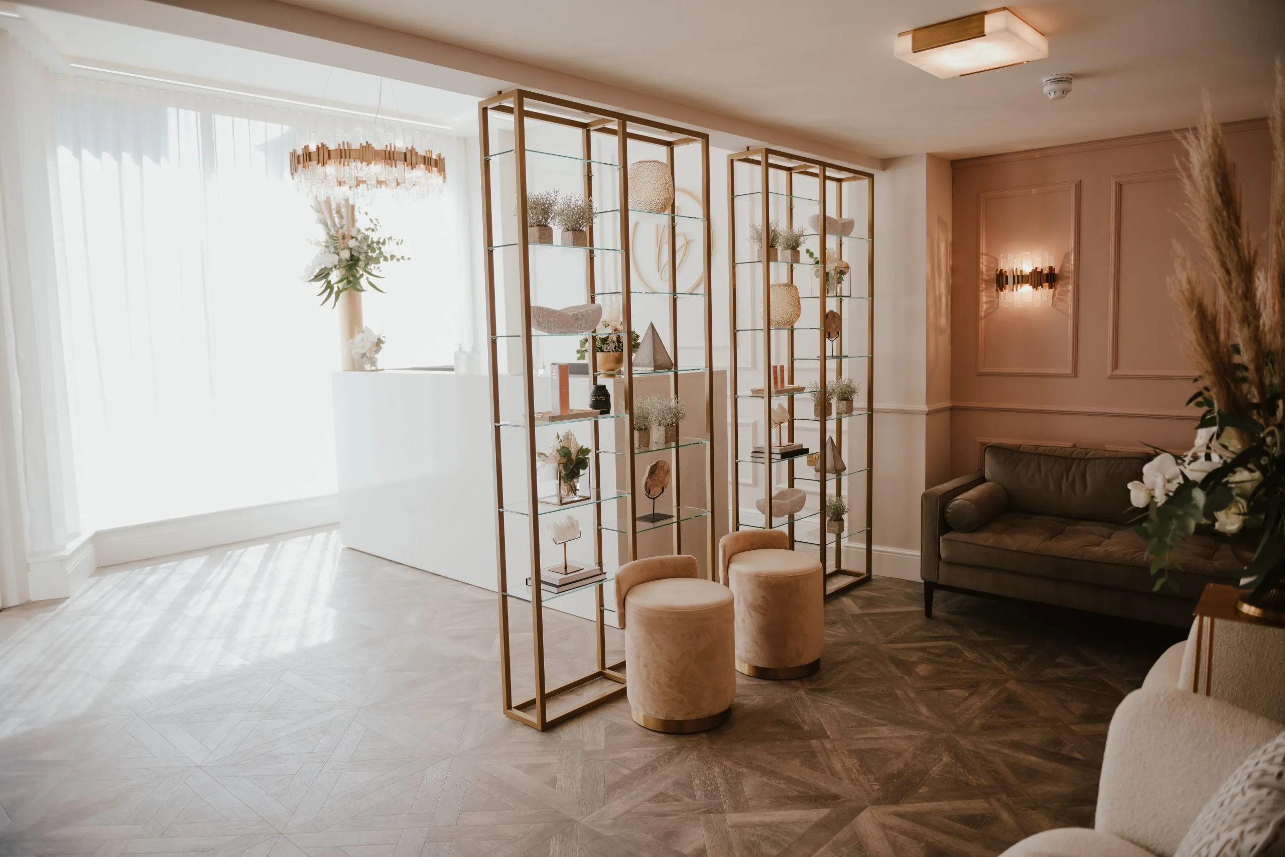Reception lounge with brass shelving screens at Blossom Cosmetic Clinic, York