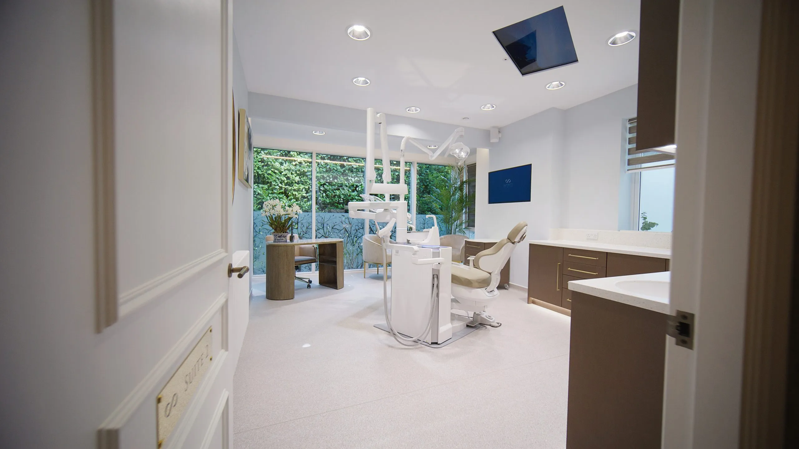 Dental surgery with dark cabinetry and garden outlook at Infinity Dental Suite, Harrogate