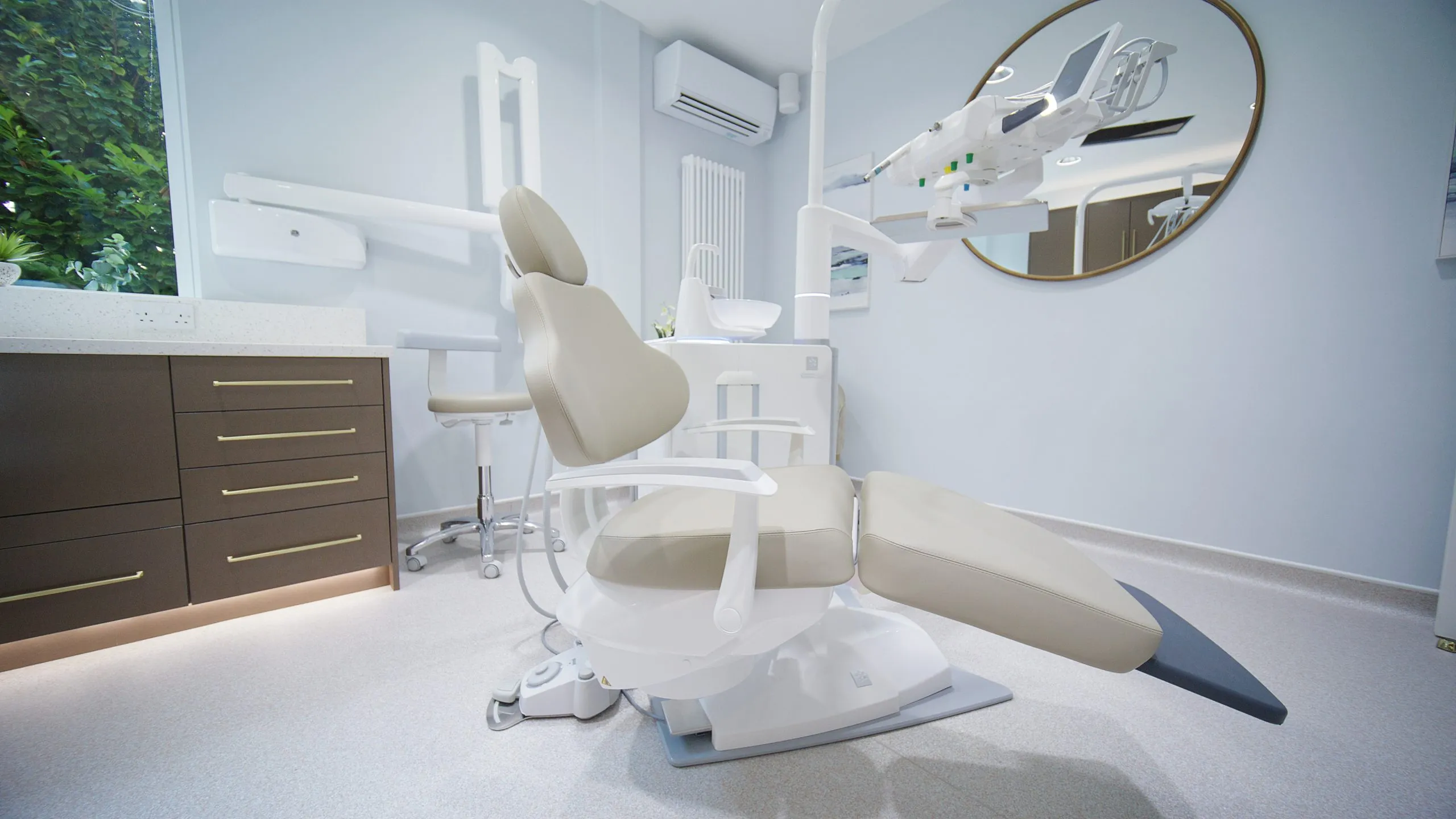 Dental chair and circular mirror in a Harrogate surgery designed by BH Projects Group