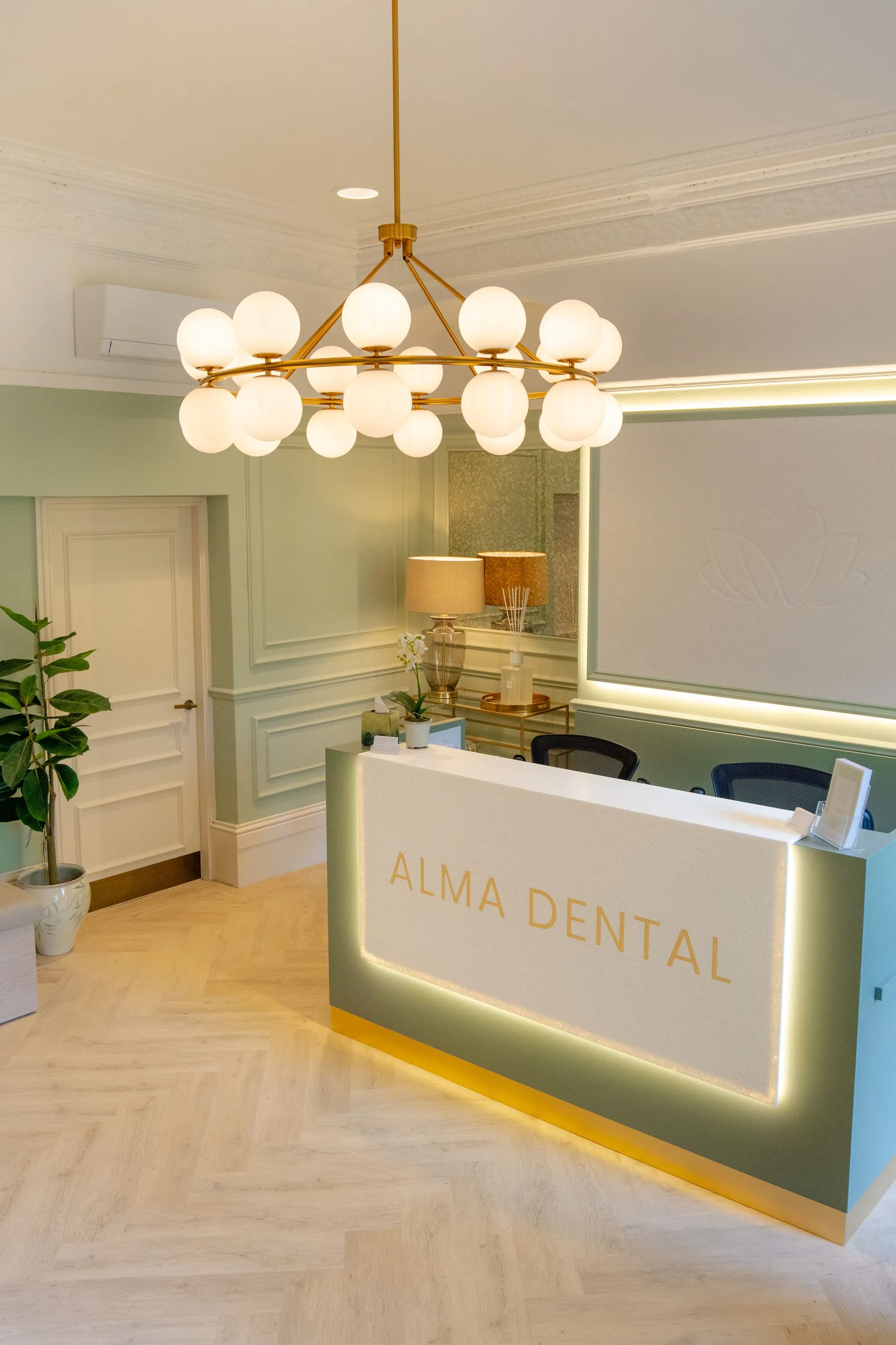 The backlit Alma Dental reception desk in North Shields