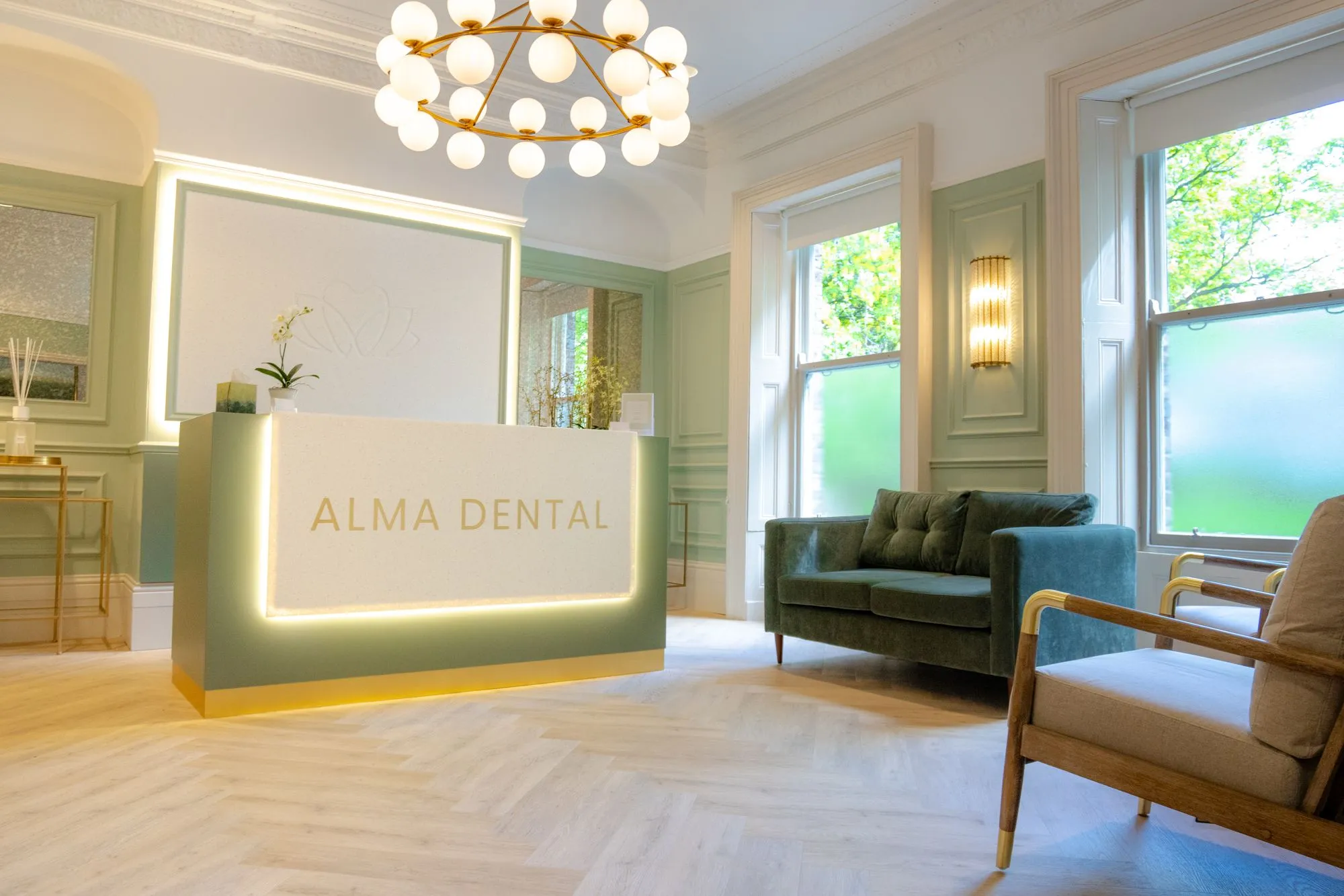 The completed waiting room at Alma Dental with green seating and panelled walls