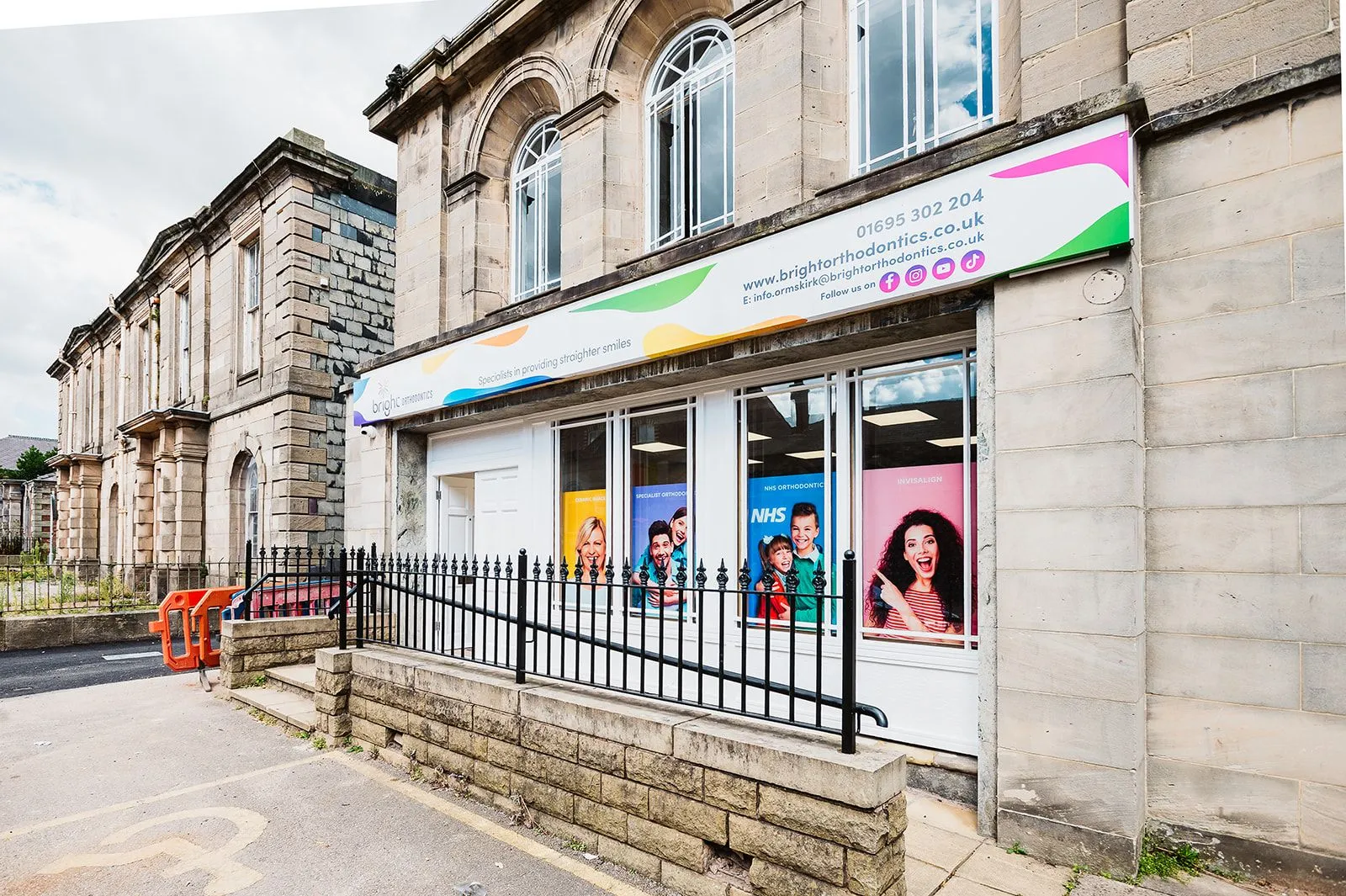 Stone building frontage with branded window graphics at Bright Orthodontics, Ormskirk