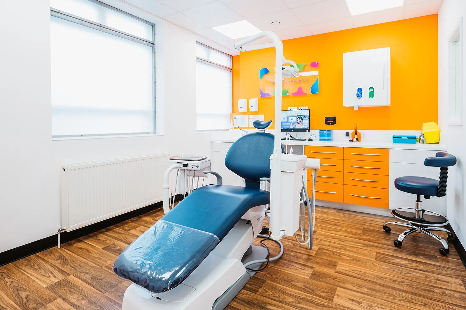 Orthodontic surgery with orange cabinetry at Bright Orthodontics, Ormskirk