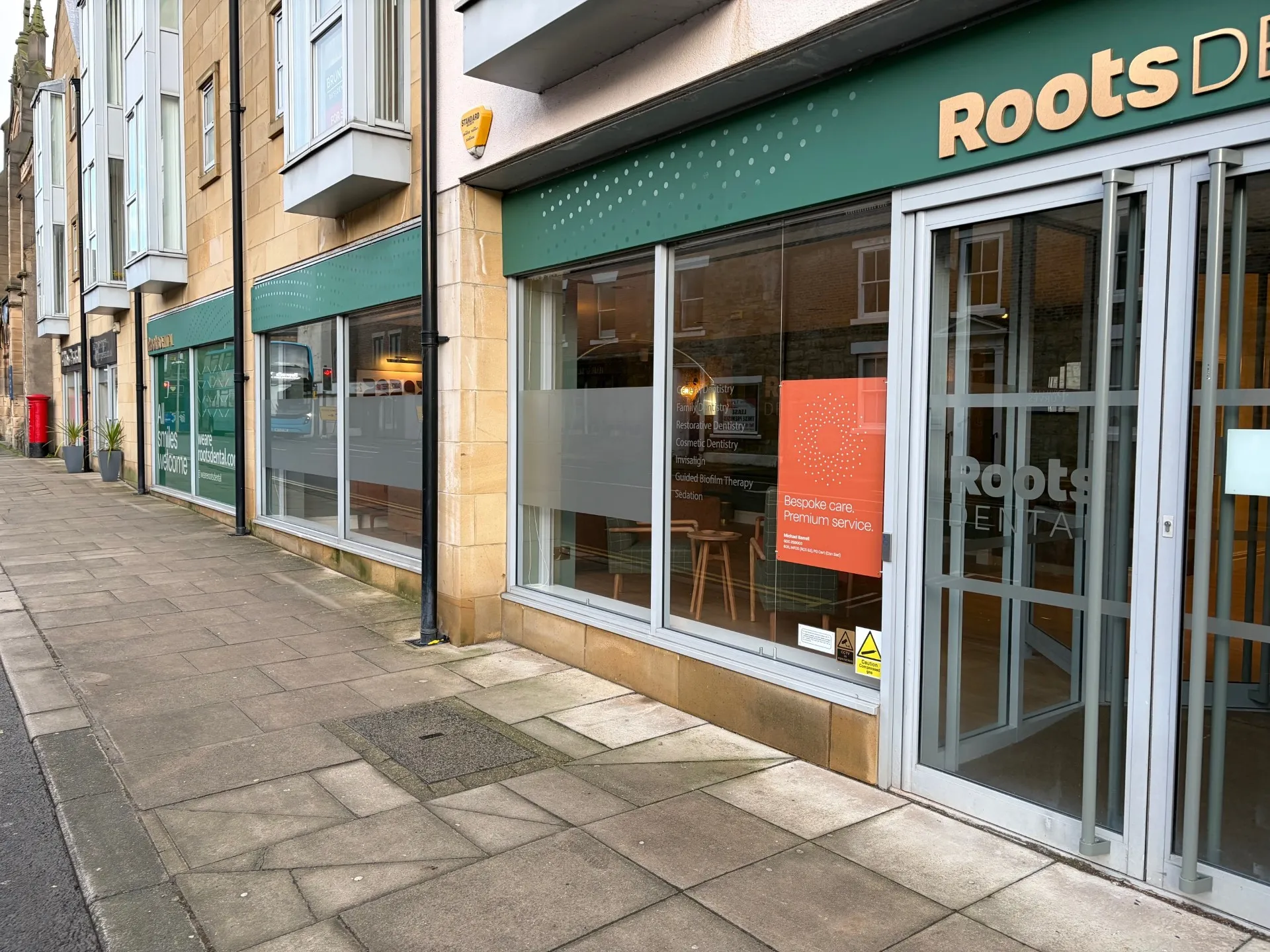 Street frontage and signage of Roots Dental in Morpeth town centre